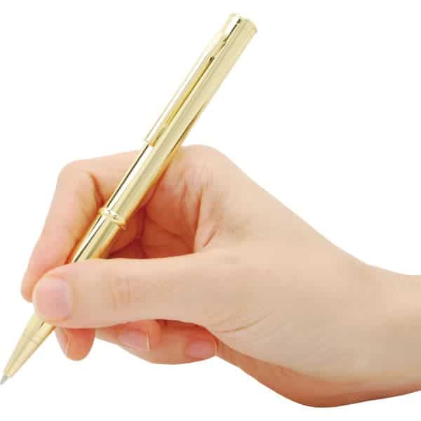 Hand holding a sleek gold pen, poised for writing on a white background.