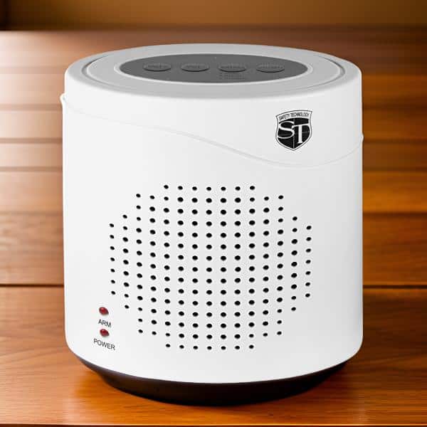 White tabletop air purifier with digital controls and vented design on a wooden surface.