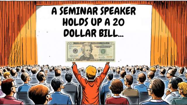 Seminar speaker on stage holds up a $20 bill to a large audience, highlighting a point or message.