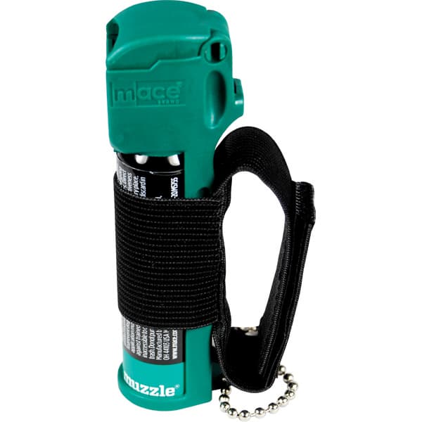 Green mace pepper spray with black wrist strap for personal safety.