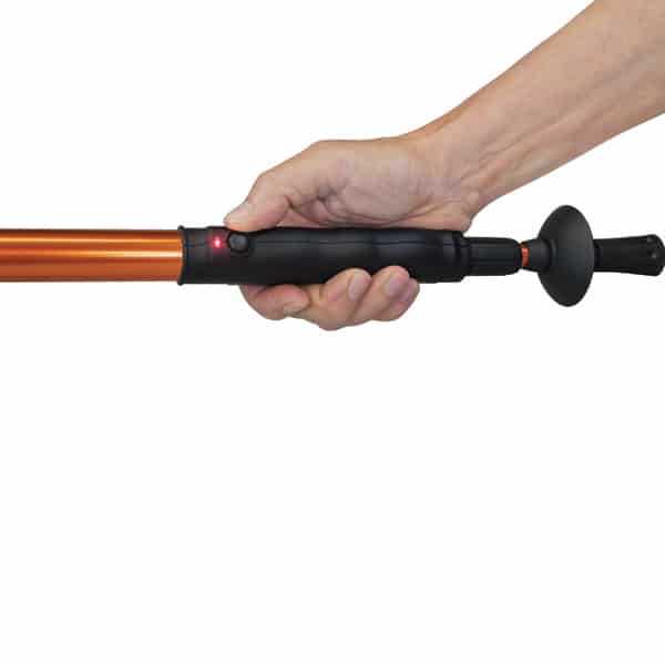 Hand holding an orange electric fishing net handle with a black grip and red indicator light.