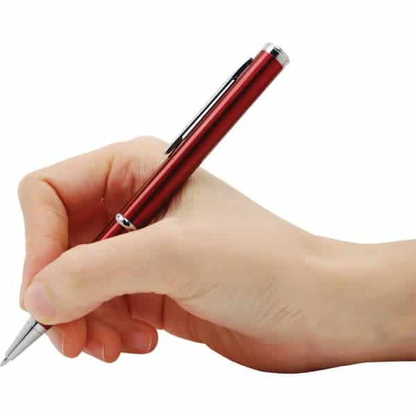 Hand holding a sleek red pen poised for writing on a blank surface.