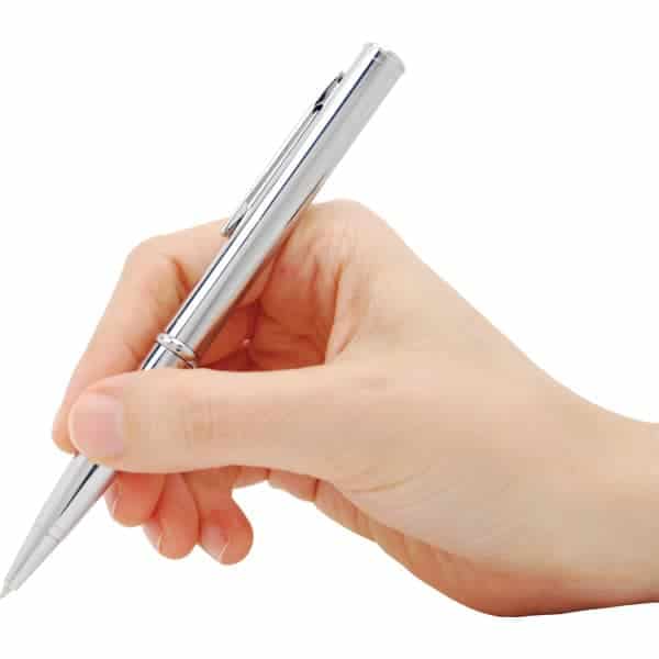 Hand holding silver pen poised for writing on white background.