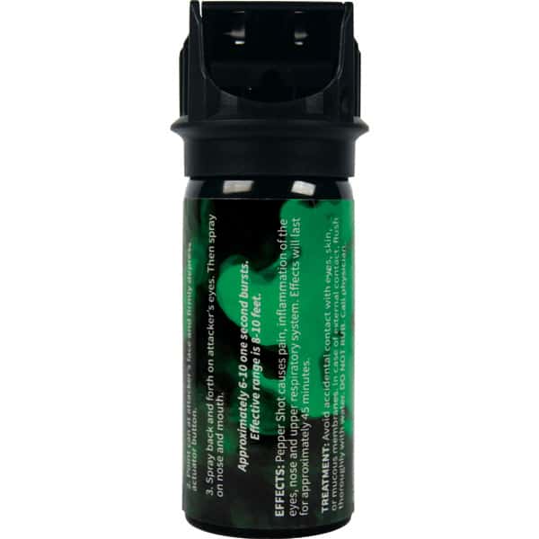 Close-up of a black and green pepper spray canister with safety and usage instructions visible on the label.