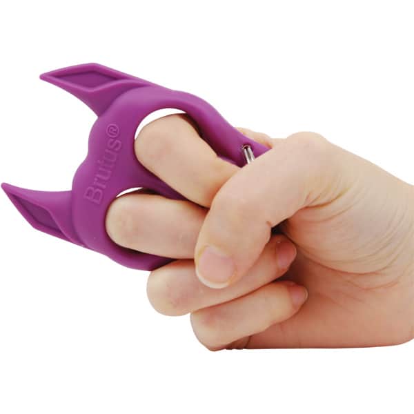 Hand holding a purple self-defense keychain tool, shaped like a dog.