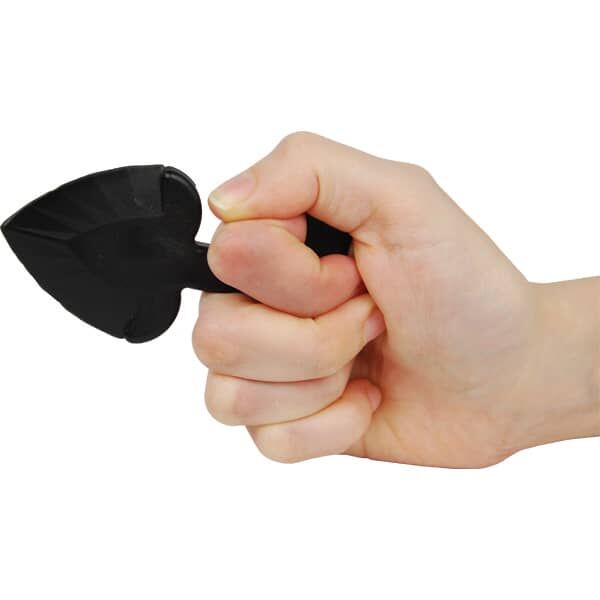 Hand holding a black plastic self-defense tool shaped like a small spade, isolated on white background.