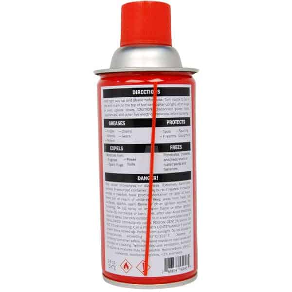 Red spray lubricant can with instructions and safety warnings on the label, featuring a long straw attached.