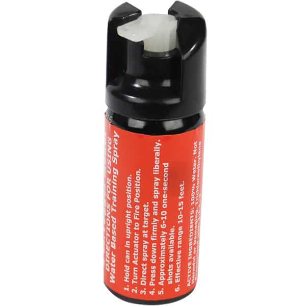 Pepper spray canister with red label and safety instructions, ergonomic design for easy handling.