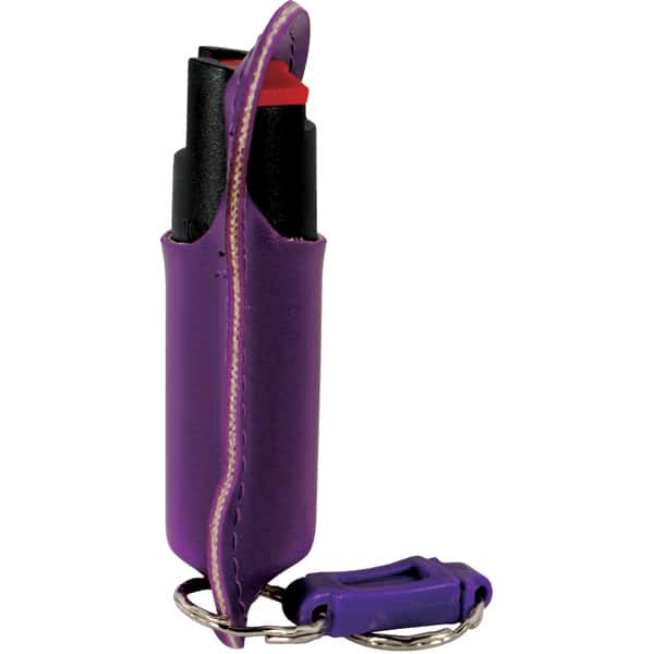 Purple pepper spray keychain in holder for personal safety. Compact, easy-to-carry self-defense accessory.